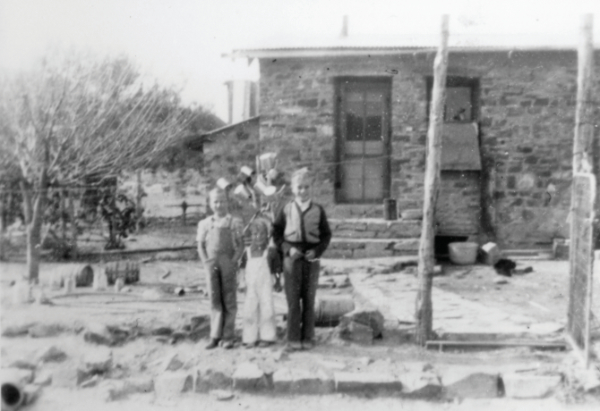 Charles H., Fred, and Joe Pete Wood at the Wood Ranch home, 1935.