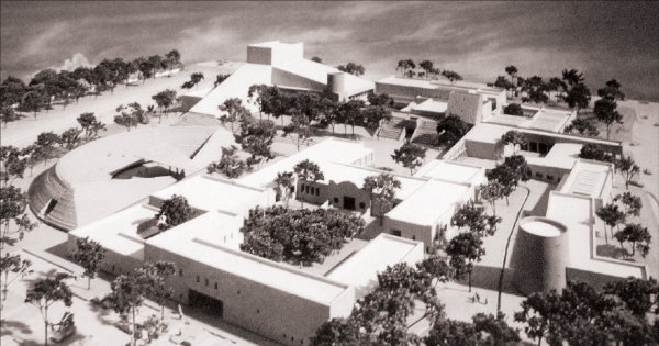 With the choice of the Barelas neighborhood location at Bridge (now Avenida Dolores Huerta) and 4th streets, the original campus plan was condensed to fit the 16-acre site. Noticeably absent in this revised design is the charreada lienzo (rodeo arena). The design focused on pedestrian access to the renovated historic elementary school (today’s History and Literary Arts Building), a visual arts building with numerous museum galleries, a performing arts building with three theaters, an international and education building housing the Instituto Cervantes, two torreóns (watchtowers) exhibiting art, and an amphitheater. Image courtesy the National Hispanic Cultural Center.