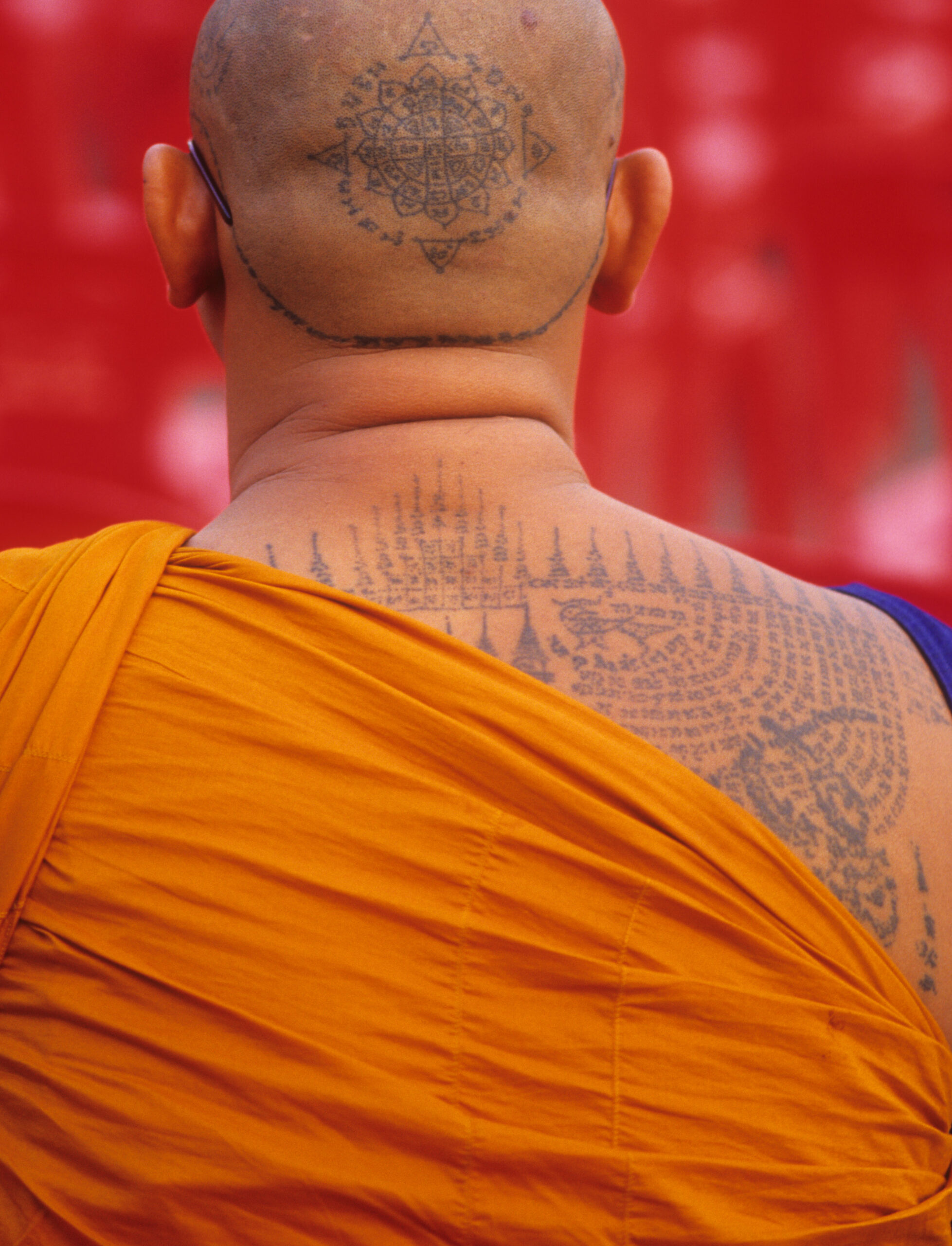 This Theravada Buddhist monk of Wat Bang Phra in Thailand has a sacred Mongkut Phra Puttha Chao yantra tattooed on his head, believed to impart prosperity, protection, and luck. Photograph by Lars Krutak.
