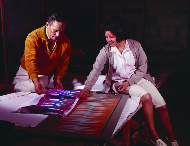 Lloyd Kiva New in the textile-printing studio with an IAIA student, ca. 1965. Photograph by Kay V. Wiest. Courtesy of Kay V. Wiest Collection, IAIA Archives, Santa Fe, New Mexico.