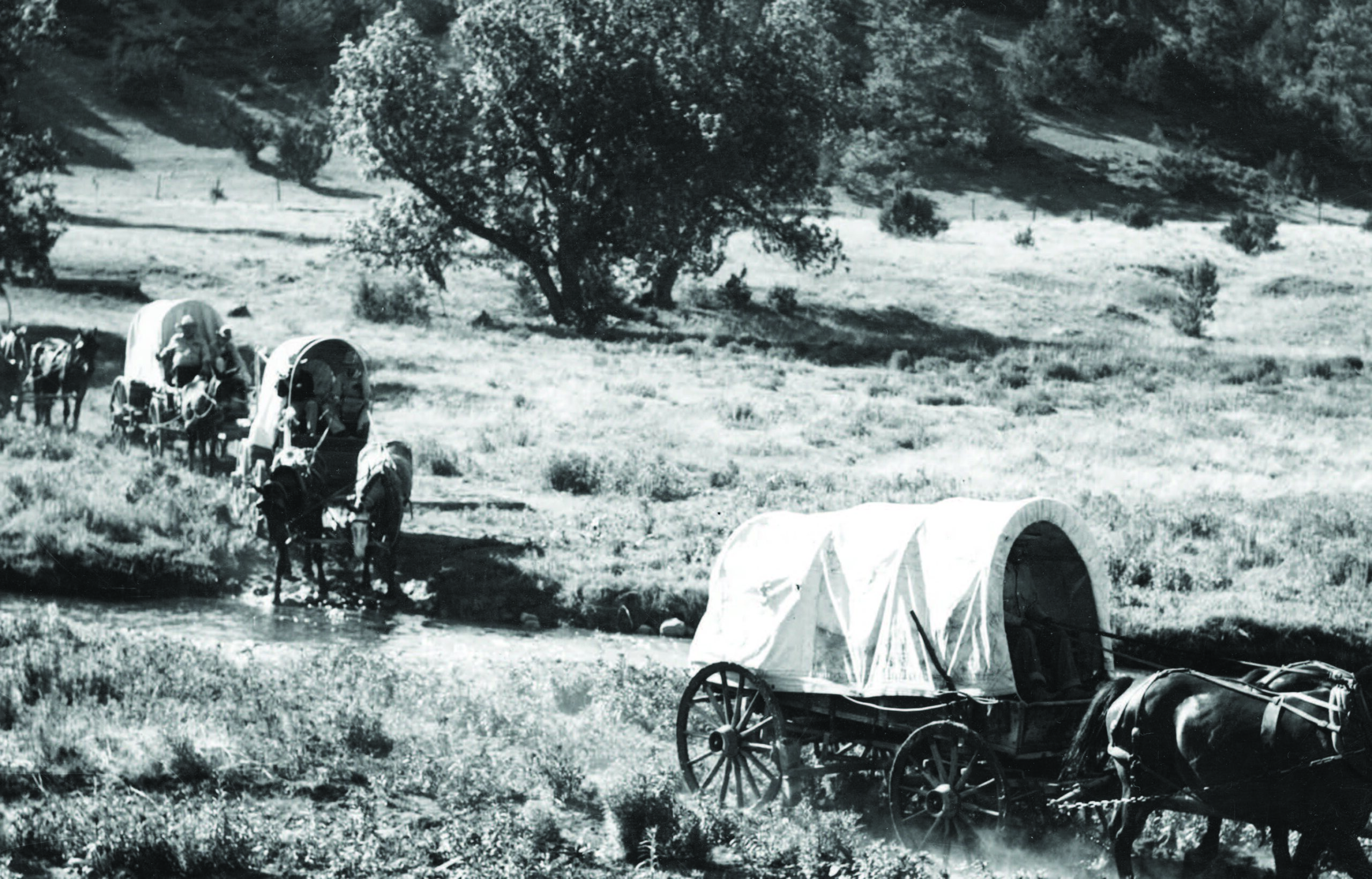 A latter-day wagon train crossing an unidentified stream in New Mexico. Photograph by the New Mexico Tourism Bureau, ca. 1940. Palace of the Governors Photo Archives (NMHM/DCA), Neg. No. 128733.