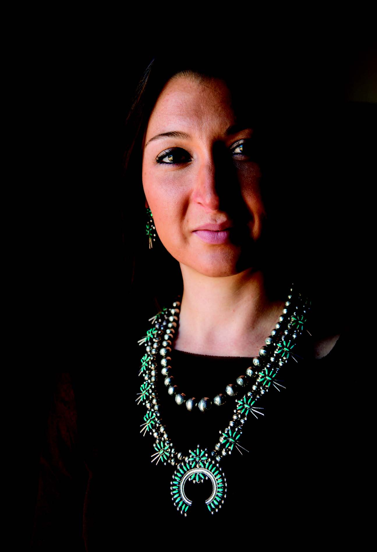 Helen Tindel, the author’s daughter, wearing Navajo silver beads and a Zuni needlepoint necklace and earring set, all from the collections of the Museum of Indian Arts and Culture. The Zuni set is on view at the museum in Turquoise, Water, Sky: The Stone and Its Meaning. Photograph by Kitty Leaken.