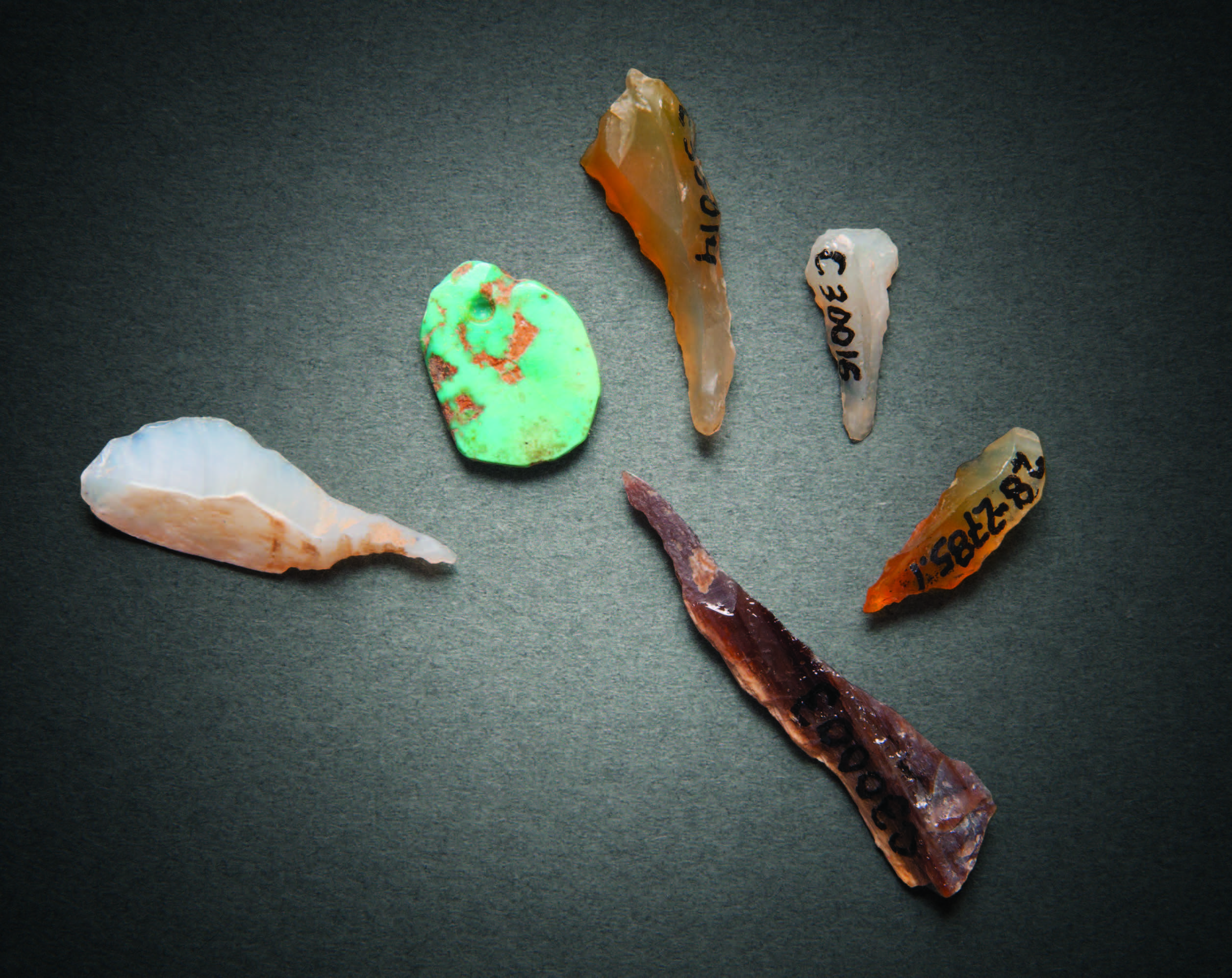A partially drilled turquoise pendant with drilling tools. Courtesy Chaco Culture National Historical Park, Museum Collection Catalog Nos. 30391, 3003, 30016, 30004, 30014, Hibben Center at the University of New Mexico. Photograph by Blair Clark.