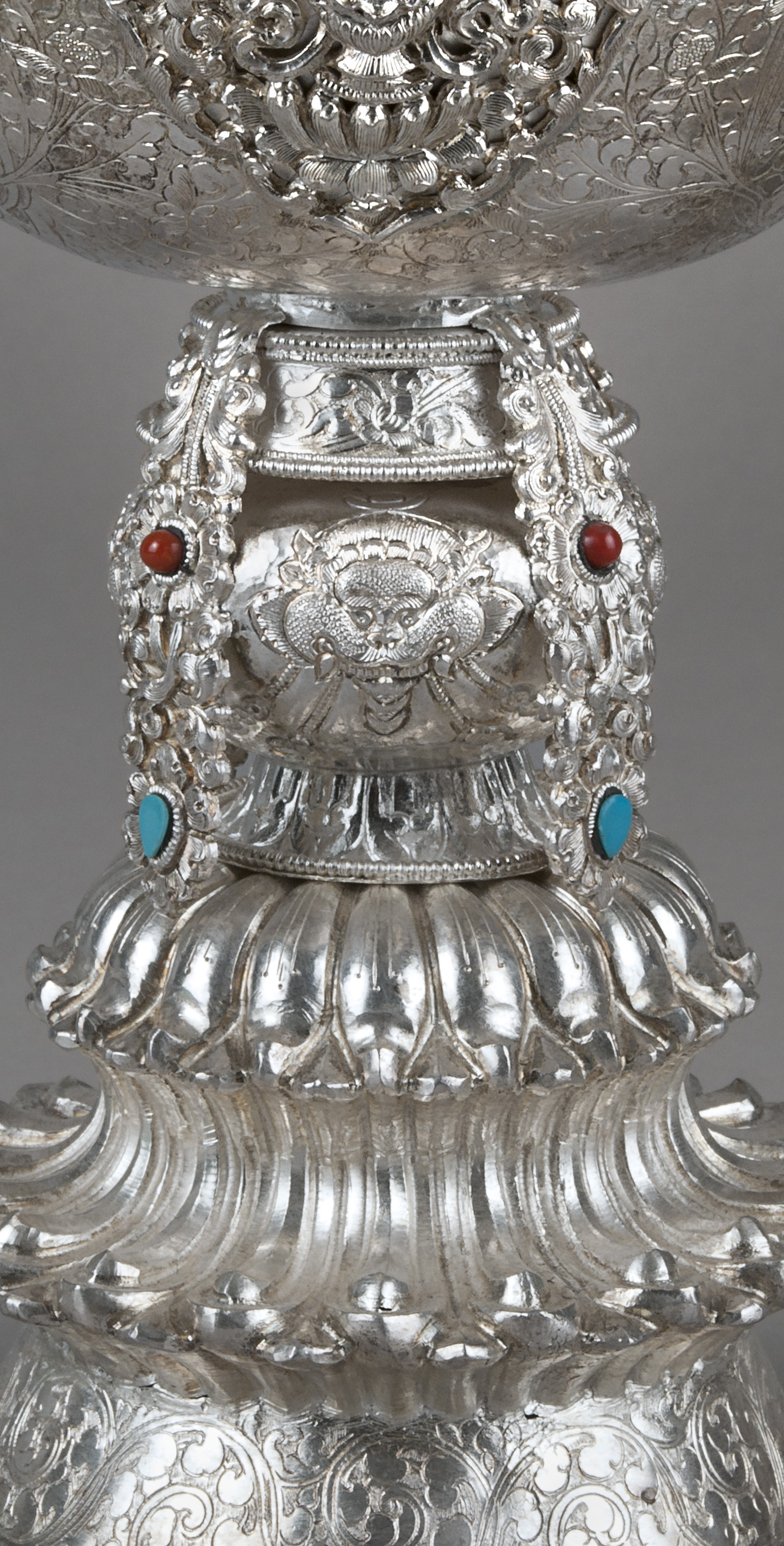 Butter lamps illuminate Buddhist altars during daily prayer and special ceremonies. The light provides clarity to help one overcome ignorance. Traditionally, lamps burn clarified yak butter, although today readily available butters and oils may be used. This example uses precious material — silver, turquoise, and coral — to beautify the item. Made by Tibetan artist Sero Kelsang, Dharmsala, Himachal Pradesh, India, ca. 1996. Silver, coral, turquoise. Museum of International Folk Art, IFAF Collection (FA.1996.11.1). Photograph by Blair Clark.