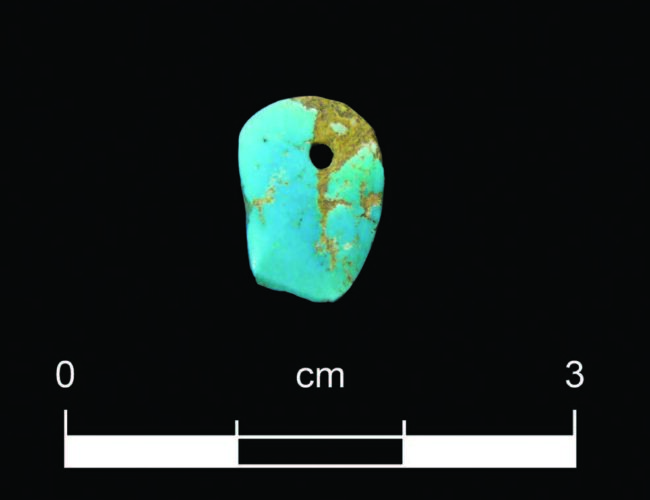 Turquoise ornament recovered from Ogapogeh Pueblo during the excavation prior to the construction of the Santa Fe Community Convention Center. Photograph by Scott Jaquith, Office of Archaeological Studies.