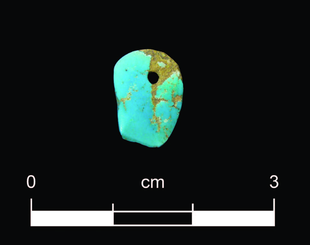 Turquoise ornament recovered from Ogapogeh Pueblo during the excavation prior to the construction of the Santa Fe Community Convention Center. Photograph by Scott Jaquith, Office of Archaeological Studies.