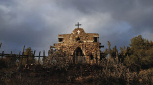 Known as La Capilla de San Ysidro Labrador, this small family chapel was built in 1928 by Lorenzo López, who used rocks gathered from his property and mud from the nearby acequia to construct the walls. Photograph by Simone Frances, 2020.