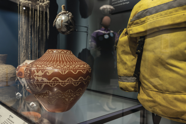Alvina Yepa’s pot dedicated to wildland firefighters is paired with gear from the Ramah Navajo Hotshot Crew in the Survival and Resilience section. Left: Alvina Yepa, Prayer and Meditation Jar, 2018. Clay, volcanic ash temper, slip. 10 ½ × 11 ¼ inches. MIAC Collection: 60290/12. Right: Shirt, Ramah Navajo Hotshot Crew, ca. 1970. Gift of Lola Henio. MIAC Collection: 60320/12.