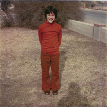 Dana poses for a Christmas picture in the front yard of the Burgess home in the Casa Solana neighborhood, 1977. Photograph courtesy Dana Tai Soon Burgess.