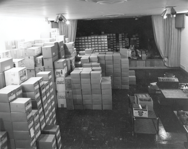 The Girard Foundation Folk Art Collection awaits processing in the auditorium at the Museum of International Folk Art, September 8, 1978.  Photograph by Art Taylor. Multiple Visions: A Common Bond, MOIFA Exhibitions (AR00004.170), Bartlett Library and Archives, Museum of International Folk Art.
