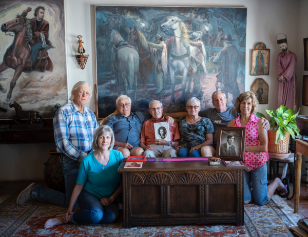 The Taylor family. Pat Taylor, Rosemary Taylor Stolberg (seated), Robert Taylor, J . Paul Taylor holding a photo of Mary Daniels Taylor, Dolores Taylor, Mike Taylor, Mary Helen Taylor Ratje holding a photo of John Paul Taylor Jr., photographed in August 2018. Photograph by Paul Ratje; courtesy the Taylor family.