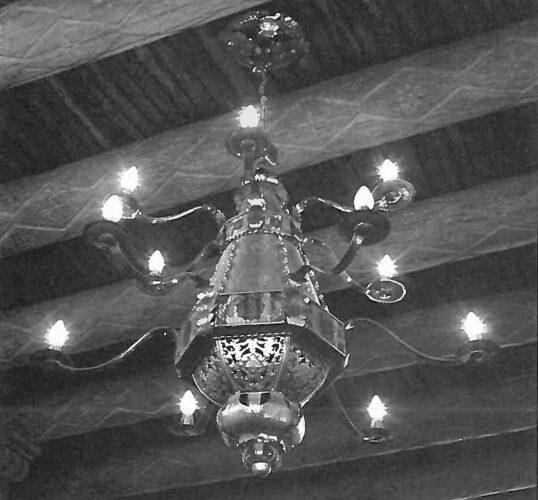 Laboratory of Anthropology foyer chandelier. Terneplate, reverse-painted glass. Approx. 60 × 55 inches. Photograph by Nancy Hunter Warren, as printed in El Palacio, vol. 87, no. 3.