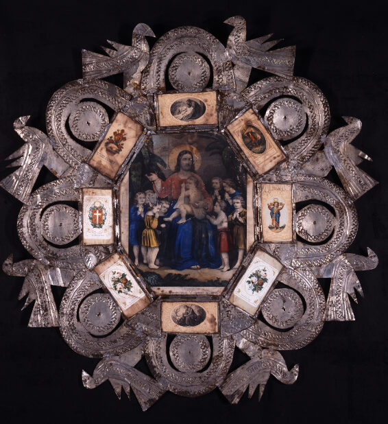 Higinio V. Gonzales, octagonal marco, ca. 1865–1880. Repurposed tinplate, glass, hand-colored devotional lithograph, assorted devotional holy cards. Current location unknown. Photograph courtesy of The Owings Gallery.