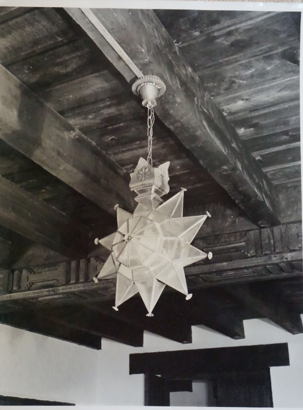 Pendant ten-point "star" lighting fixture of John Gaw Meem design, ca. 1935. Woodman's innate and accomplished capacity to interpret established Mexican, Spanish, and North African styles of lighting fixtures is evident in this masterwork. It hangs in an unidentified interior. Photograph by Wyatt Davis.