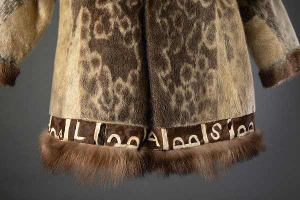 Iñupiaq or Yup’ik ancestral artist, Atigi or Atkuk (ring seal parka) (detail), 1947-48, Kuuyuk (Koyuk), Alaska. Ring seal fur, wolverine, calfskin, beaver fur, brass, cotton cloth. 49 3 ⁄16 × 19 11⁄16 × 1 15⁄16 in. Anchorage Museum Collection, gift of Neva and Walter Meyers, 2001.14.17. Photograph by Chris Arend.