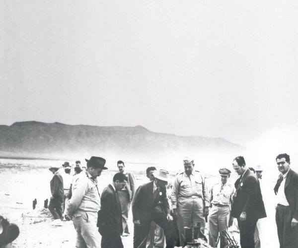 Ground Zero Trinity site, epicenter of first explosion, San Antonio, New Mexico, 1945. J. Robert Oppenheimer (center left) and Lieutenant General Groves (center) investigate the wreckage. Courtesy the Santa Fe New Mexican Collection, Palace of the Governors Photo Archives (NMHM/DCA), neg. no. HP.2014.14.1712.