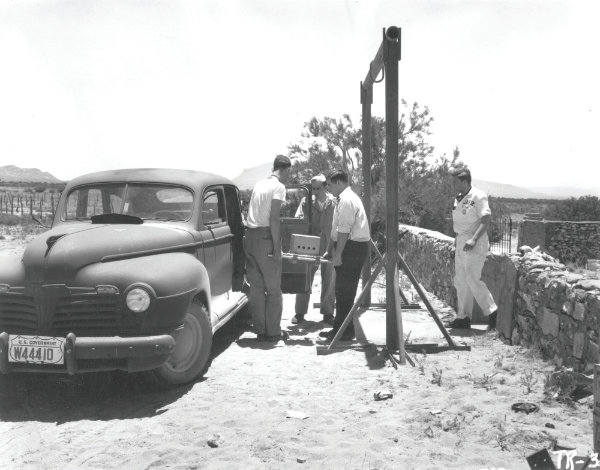 Workers from Los Alamos National Laboratory transporting equipment for the nuclear test at Trinity Site, at McDonald Ranch House, New Mexico, 1945. Courtesy the Santa Fe New Mexican Collection, Palace of the Governors Photo Archives (NMHM/DCA), neg. no. HP.2014.14.1713.