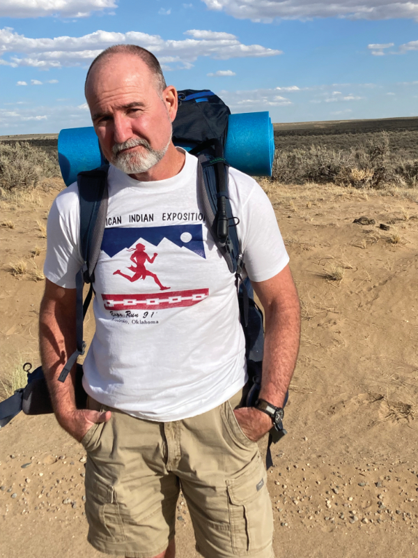 Scott Robinson hiking the Great North Road. Photograph by Scott Robinson. The t-shirt is from the 5K Robinson and Tsoodle ran together in 1991 at the American Indian Exposition in Anadarko.