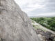 Petroglyphs of a war club, concentric circles, and a partial human figure on the lower right overlook the northern Rio Grande Valley on Mesa Prieta.